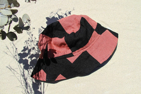 Upcycled Mauve black bucket hat presented by Not I But We.