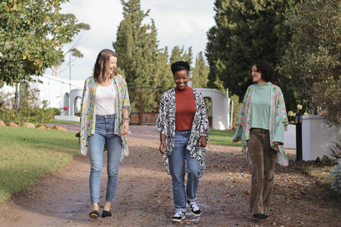 three women walking together wearing kimonos