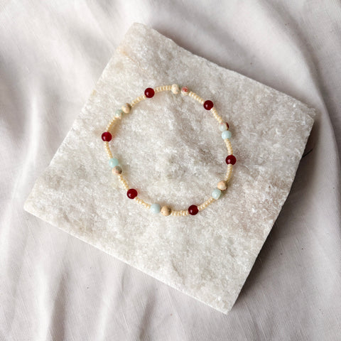 Beaded bracelet on a stone surface with a soft white background