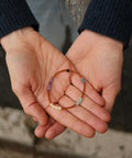 Calm Bracelet presented on someone's hands.