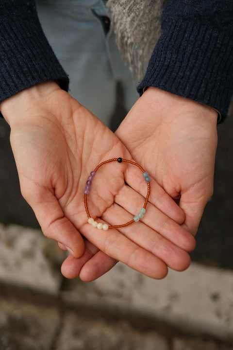 Calm Bracelet presented on someone's hands.