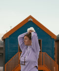 Thistle Knit Sweater in front of a Beach Hut