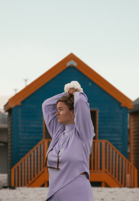 Thistle Knit Sweater in front of a Beach Hut