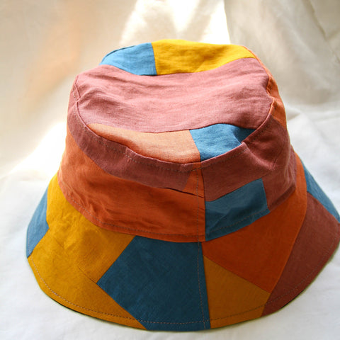 Coral Patchwork Bucket Hat with red, orange, and blue patches.