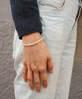 Breathe Bracelet worn by a woman with a blue jumper.