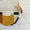 Upcycled moonbag with mustard, beige, green, and orange patches.