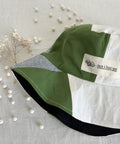 Bucket hat with brand logo and green, white, and blue linen patches.