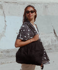 Black Tote Bag worn by a young woman