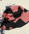 Upcycled Mauve black bucket hat presented by Not I But We. 