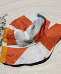 Not I But We's offwhite blue coral patchwork bucket hat with linen patches.