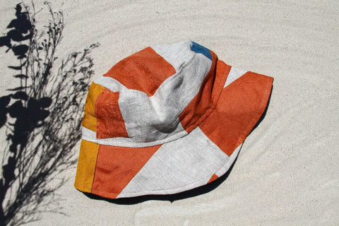Not I But We's offwhite blue coral patchwork bucket hat with linen patches.