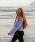 A smiling woman wearing the thistle crop sweater 