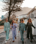 Models wearing the aw24 clothing collection in Muizenberg's streets.