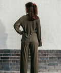 Olive plisse top combined with plisse pants presented from the back.