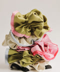 Set of colorful scrunchies on a light gray background