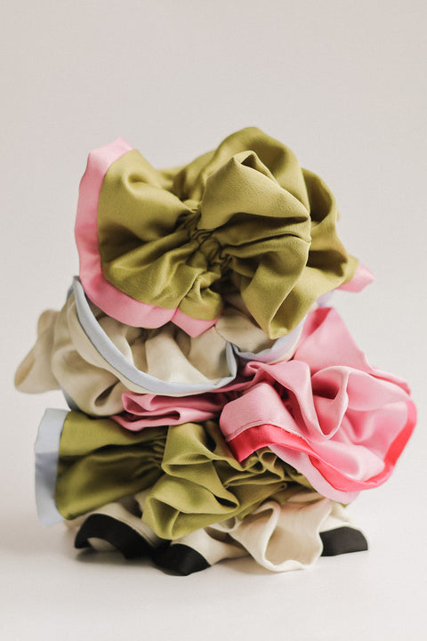 Set of colorful scrunchies on a light gray background