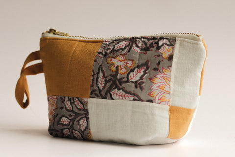 Patchwork pouch with floral patterns on a light background