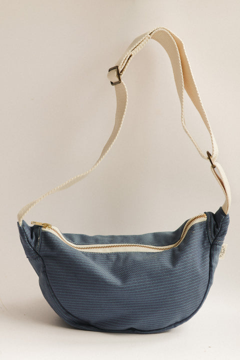 blue speckeled bag on white background