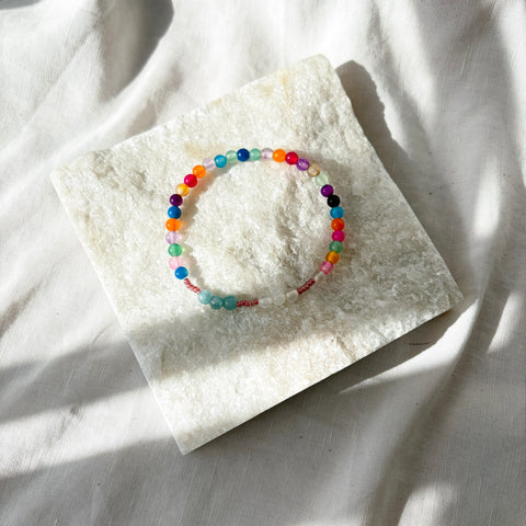 Colorful beaded bracelet on a white stone surface