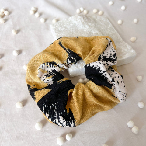 Scrunchie with black and white abstract pattern on a light background