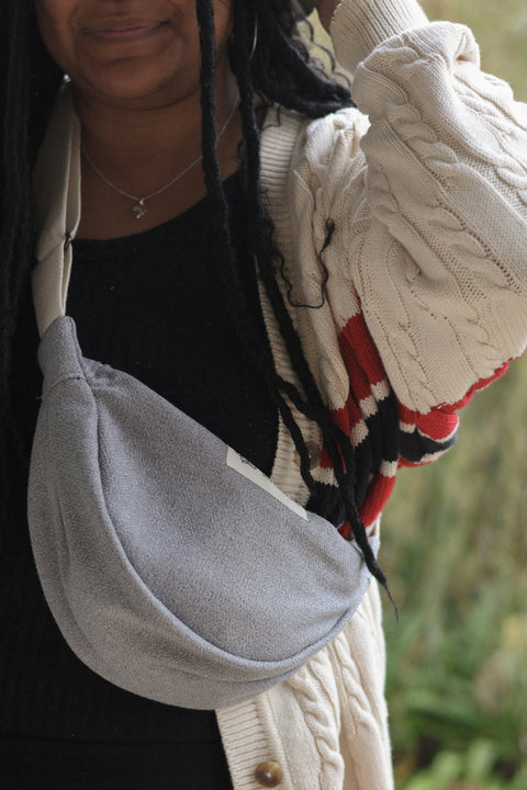 woman wearing grey blue moon bag