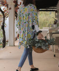 woman carrying flowers wearing a kimono