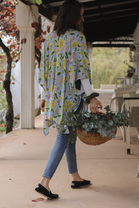 woman carrying flowers wearing a kimono
