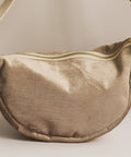 Brown fabric bag with a strap on a beige background
