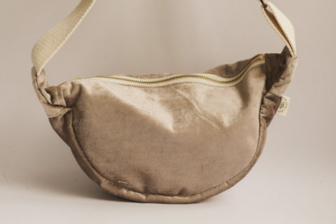 Brown fabric bag with a strap on a beige background