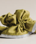 Green shoe cover on a beige background