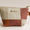 Patchwork pouch with a visible brand label on a light background