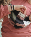 woman opening patchwork moon bag