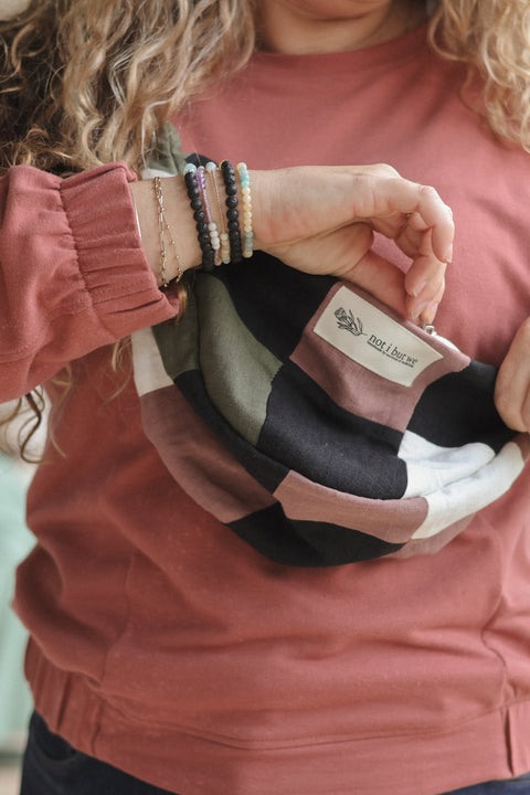 woman opening patchwork moon bag
