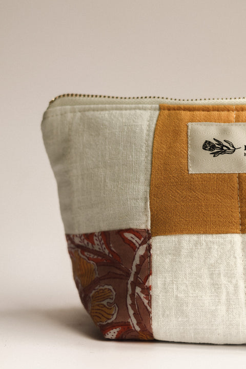Patchwork pouch with a floral pattern on a beige background