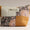 Patchwork pouch with floral patterns and a visible brand label on a neutral background