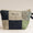 Patchwork pouch with embroidered design on a beige background