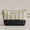 Striped fabric pouch with a black bottom section on a beige background