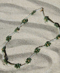 Green Daisy chain in the sand