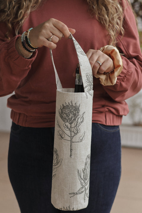 woman taking bottle out of protea wine bag