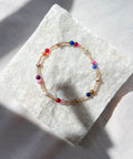 Multicolored beaded bracelet on a textured white surface