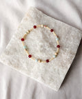 Beaded bracelet on a stone surface with a soft white background