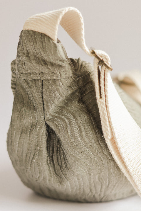 silver textured bag on white background