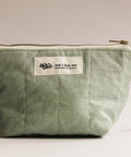 Green pouch with a visible brand label on a light background