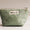 Green pouch with a visible brand label on a light background