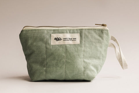 Green pouch with a visible brand label on a light background