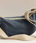 blue crossbody bag on white blackground