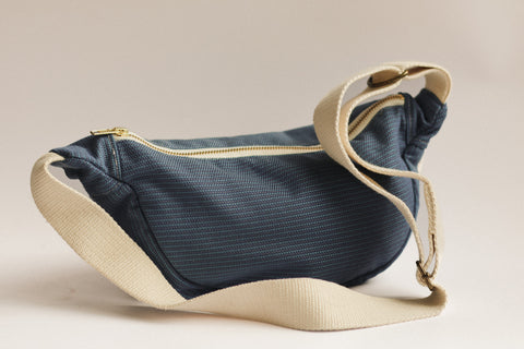 blue crossbody bag on white blackground