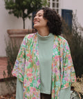 woman laughing wearing floral kimono
